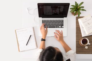 Top view of person working online on computer