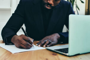 close up hands writing on paper
